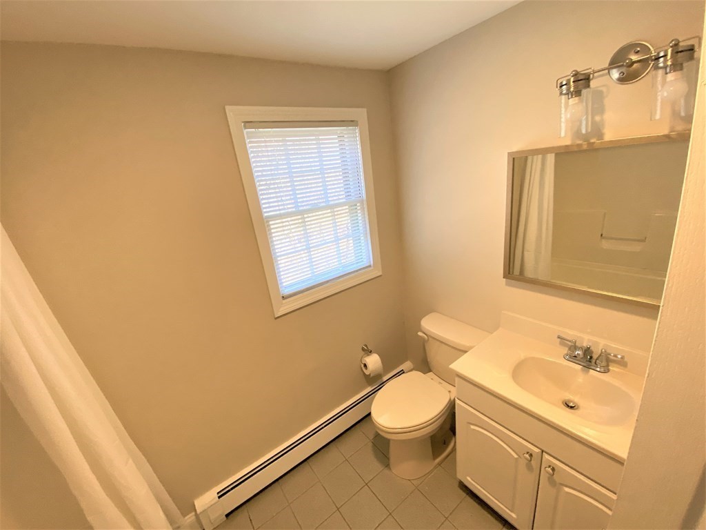 15 Appaloosa Drive, Unit 15 Methuen, MA 01844 - Photo 14 of 23 a bathroom with a sink a toilet and vanity