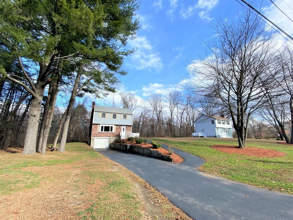 15 Appaloosa Drive, Unit 15 Methuen, MA 01844 - Photo 2 of 23 a view of a yard with cars parked in front of it