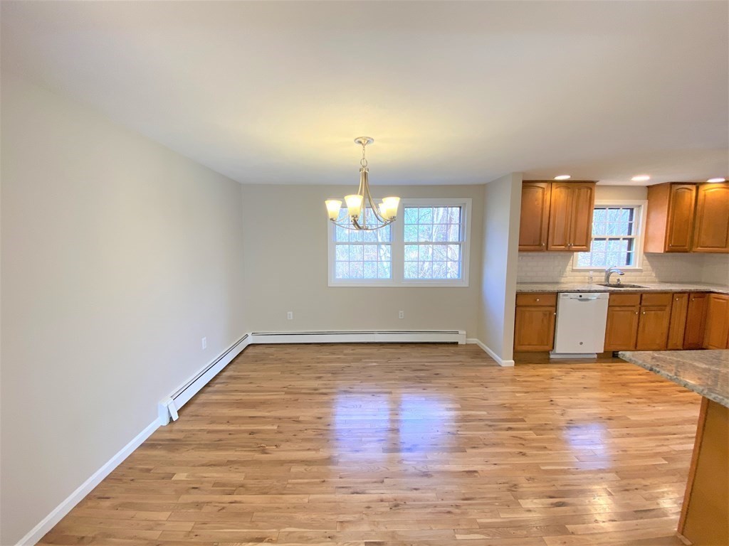 15 Appaloosa Drive, Unit 15 Methuen, MA 01844 - Photo 7 of 23 a view of a kitchen with wooden floor and a hallway