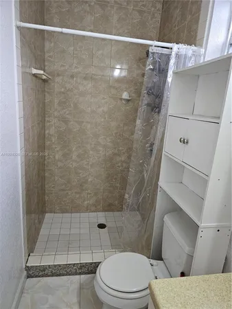 a bathroom with a toilet and shower