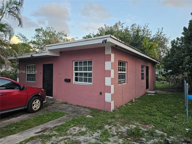 a red car parked in front of a house