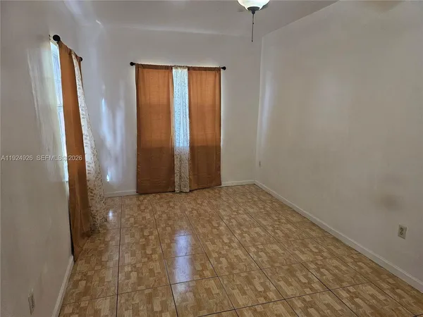 an empty room with windows and closet