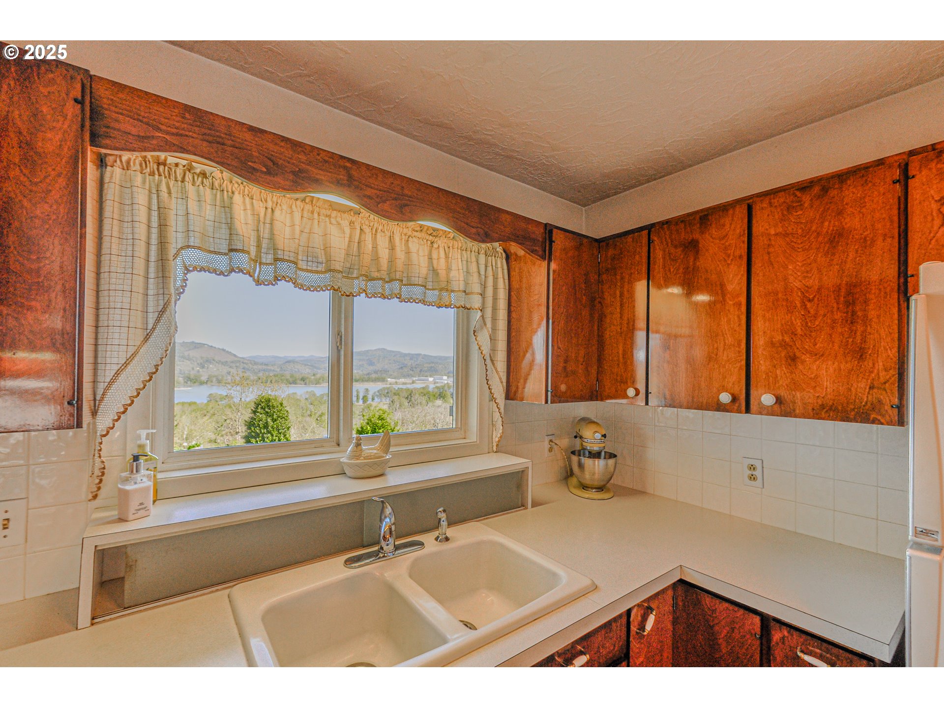 72164 Little Jack Falls Road Rainier, OR 97048 - Photo 11 of 48 a kitchen with a large window cabinets and outdoor space