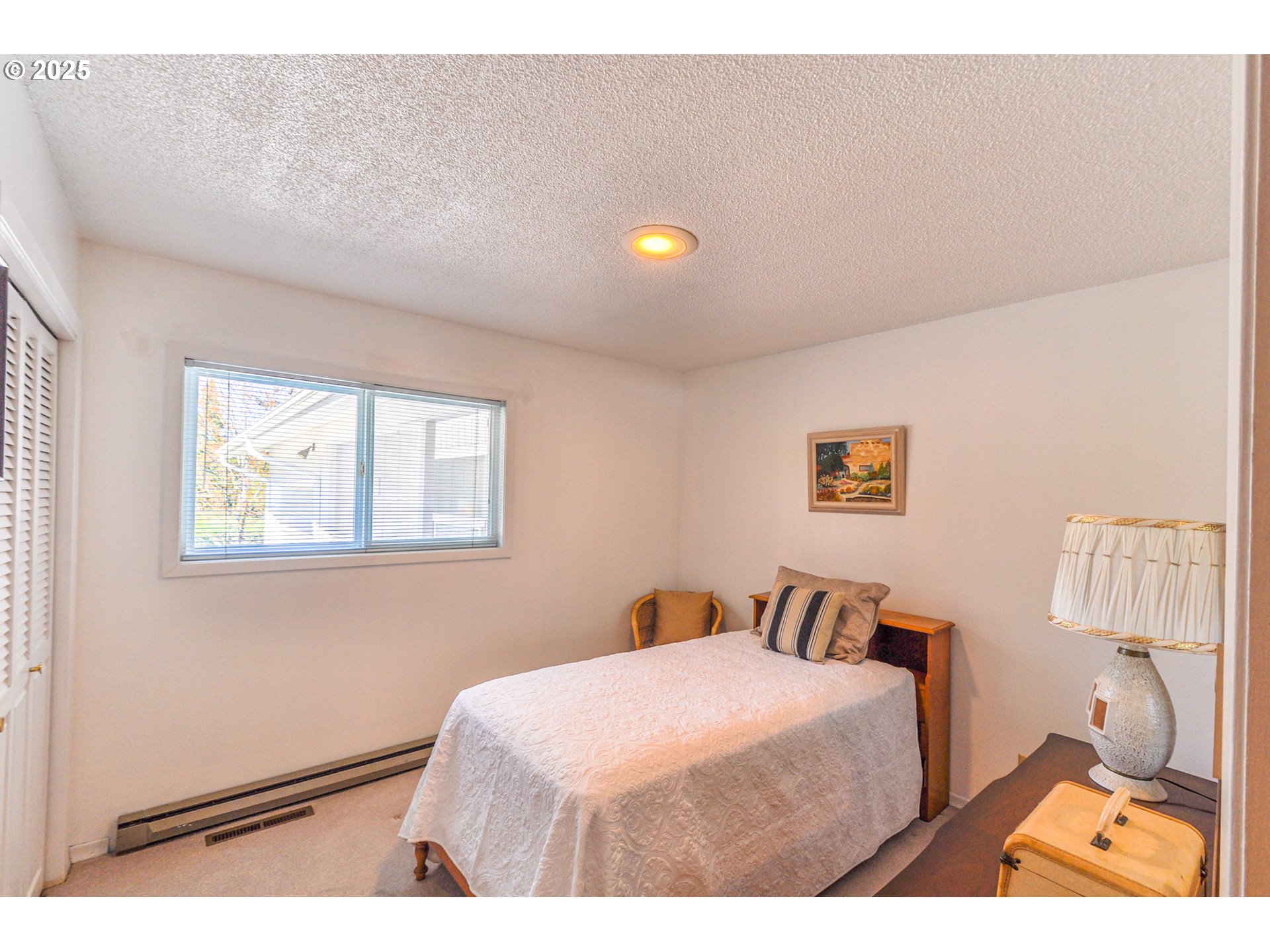 72164 Little Jack Falls Road Rainier, OR 97048 - Photo 20 of 48 a bedroom with a bed and a lamp