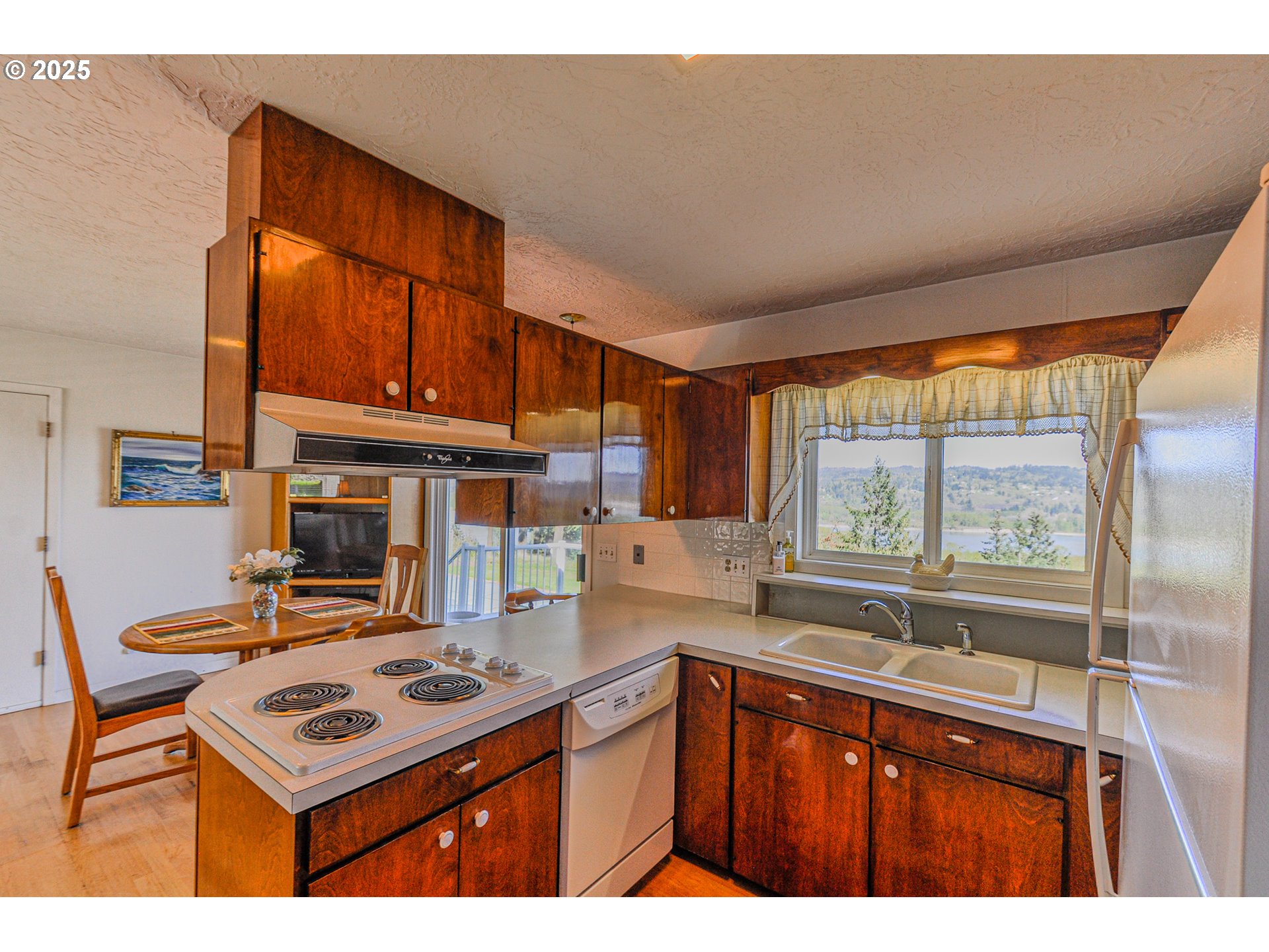 72164 Little Jack Falls Road Rainier, OR 97048 - Photo 10 of 48 a kitchen with a stove a sink and a refrigerator