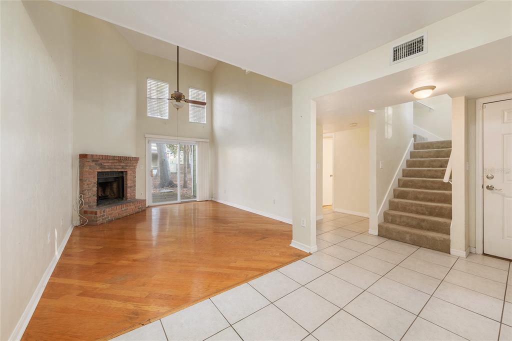 345 Northwest 48th Boulevard, Unit K Gainesville, FL 32607 - Photo 11 of 50 an empty room with fireplace and windows