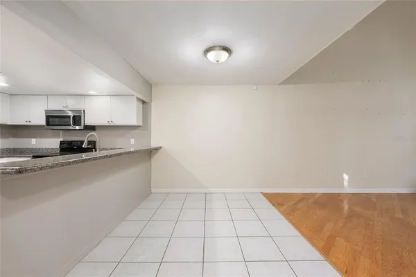 a view of kitchen with white cabinets
