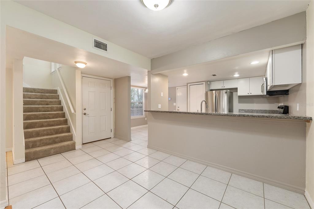345 Northwest 48th Boulevard, Unit K Gainesville, FL 32607 - Photo 17 of 50 a view of kitchen with cabinets and refrigerator