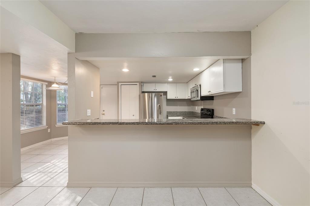 345 Northwest 48th Boulevard, Unit K Gainesville, FL 32607 - Photo 18 of 50 a kitchen with stainless steel appliances a sink and a stove