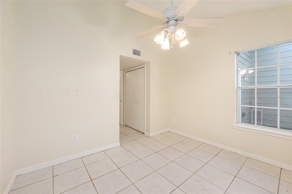 345 Northwest 48th Boulevard, Unit K Gainesville, FL 32607 - Photo 25 of 50 an empty room with windows and fan