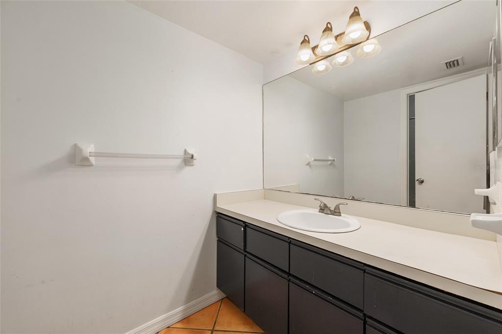 345 Northwest 48th Boulevard, Unit K Gainesville, FL 32607 - Photo 26 of 50 a bathroom with a sink a vanity and mirror