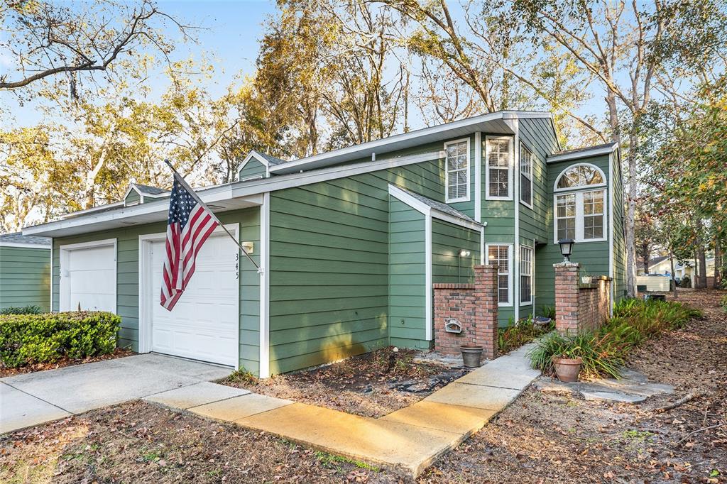 345 Northwest 48th Boulevard, Unit K Gainesville, FL 32607 - Photo 3 of 50 a front view of a house with garden