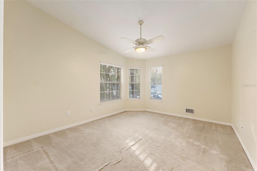 345 Northwest 48th Boulevard, Unit K Gainesville, FL 32607 - Photo 35 of 50 wooden floor in an empty room with a window