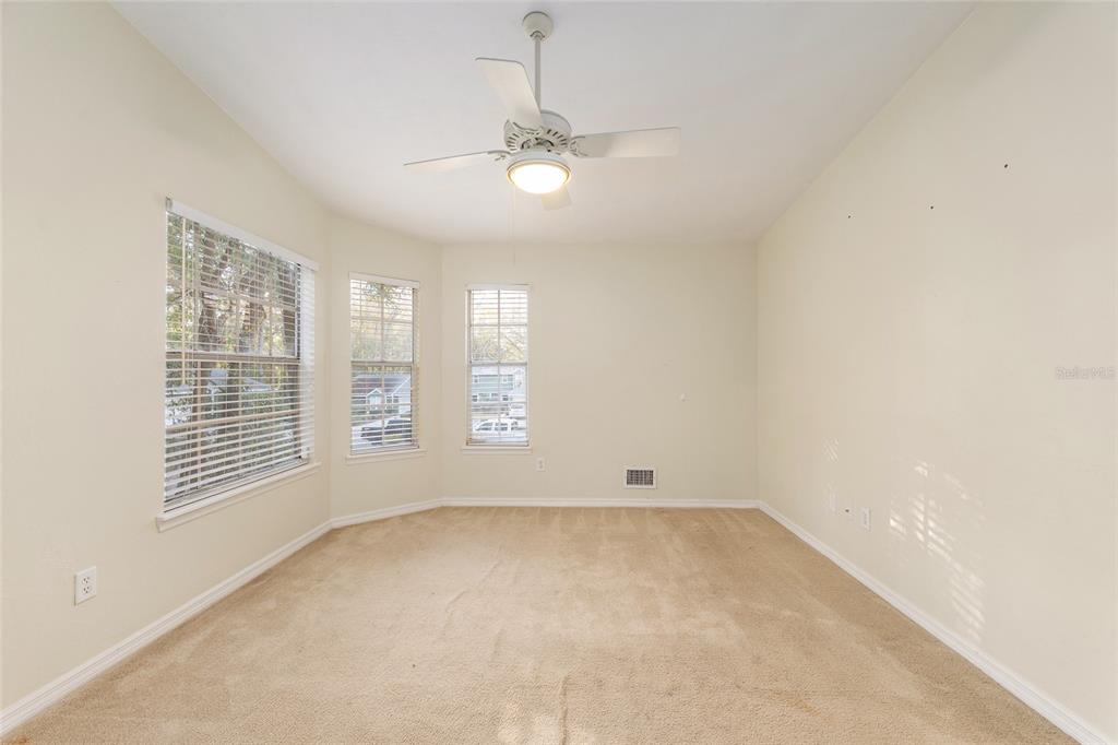 345 Northwest 48th Boulevard, Unit K Gainesville, FL 32607 - Photo 36 of 50 an empty room with windows and fan