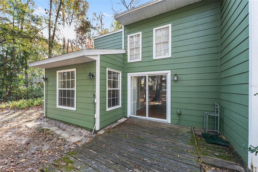 345 Northwest 48th Boulevard, Unit K Gainesville, FL 32607 - Photo 48 of 50 a view of a house with a large window and wooden floor