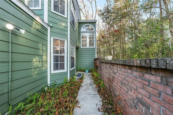 a view of a pathway of a house with a yard
