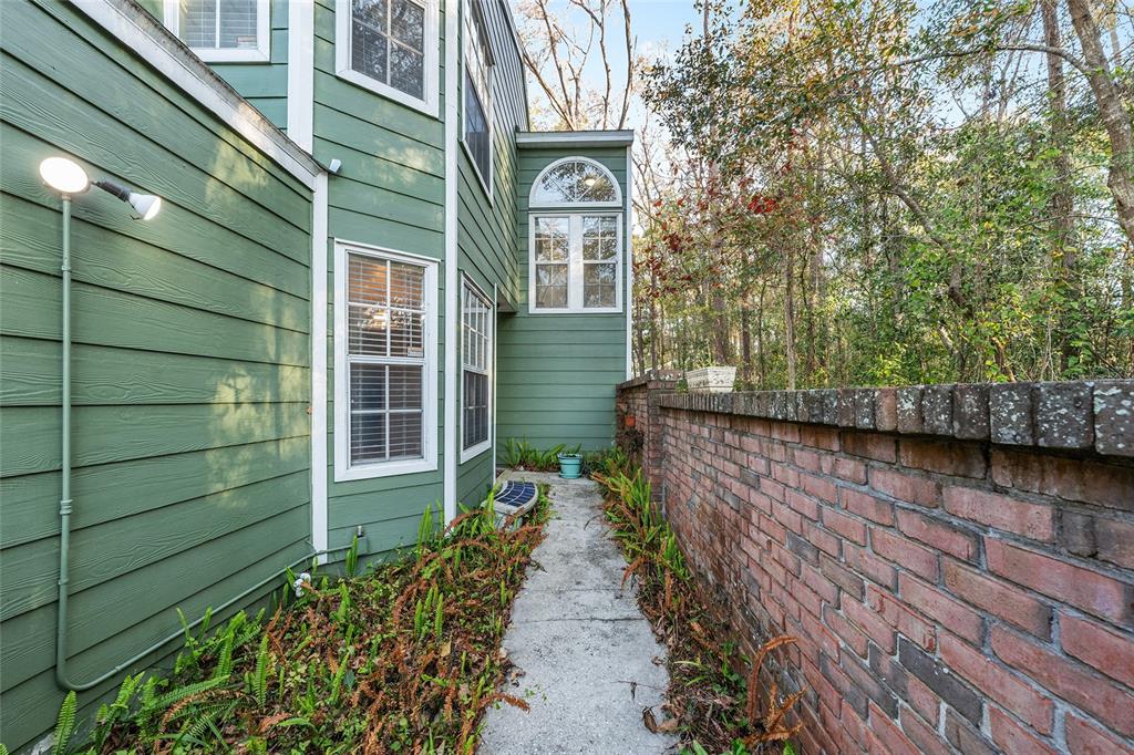 345 Northwest 48th Boulevard, Unit K Gainesville, FL 32607 - Photo 6 of 50 a view of a pathway of a house with a yard