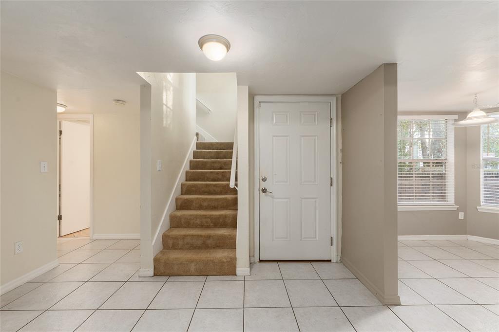 345 Northwest 48th Boulevard, Unit K Gainesville, FL 32607 - Photo 9 of 50 a view of entryway with stairs and wooden floor