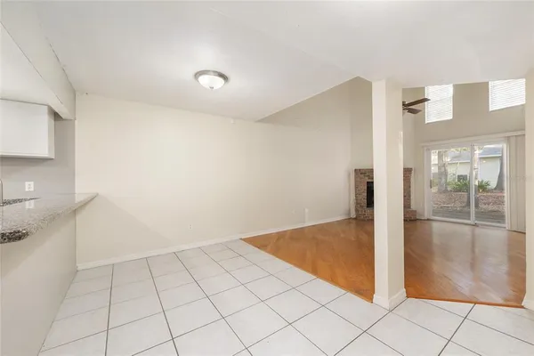 an empty room with fireplace and windows
