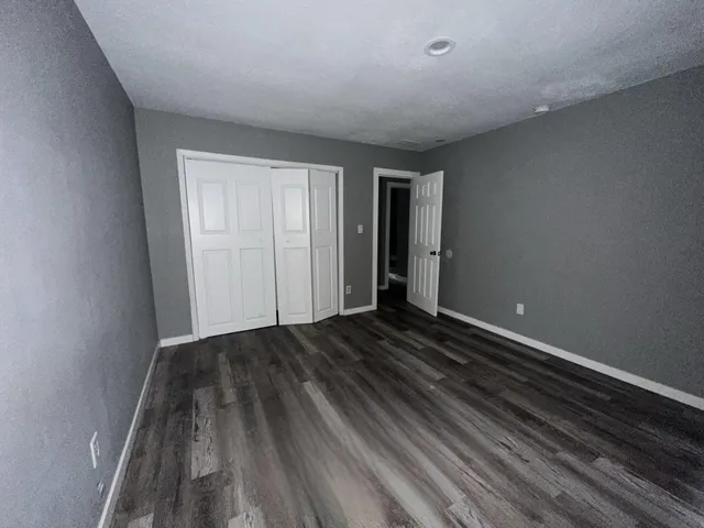 a view of a room with wooden floor