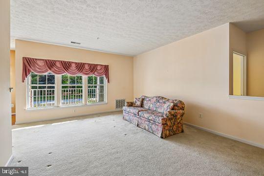 9511 Kingscroft Terrace, Unit 9511F Perry Hall, MD 21128 - Photo 15 of 38 a spacious bedroom with a bed and a window