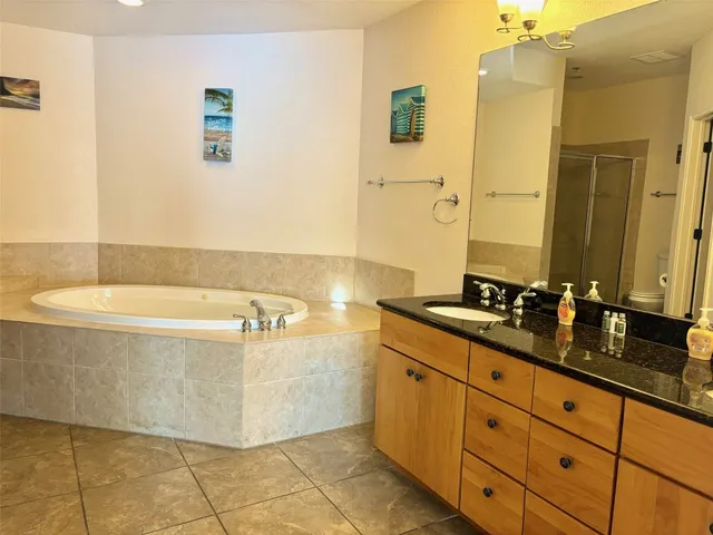 a bathroom with a tub sink and mirror