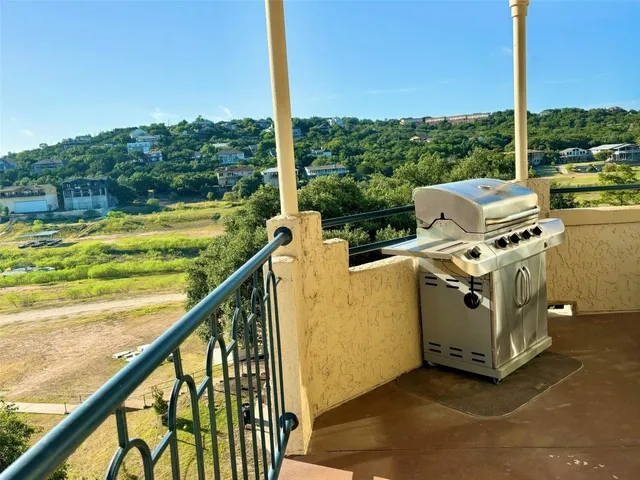 a view of a balcony with wooden floor and outdoor seating