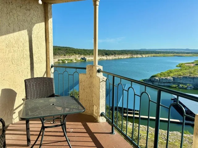 a view of a balcony with wooden floor and chair
