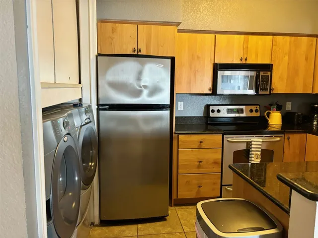 a kitchen with a refrigerator and a sink
