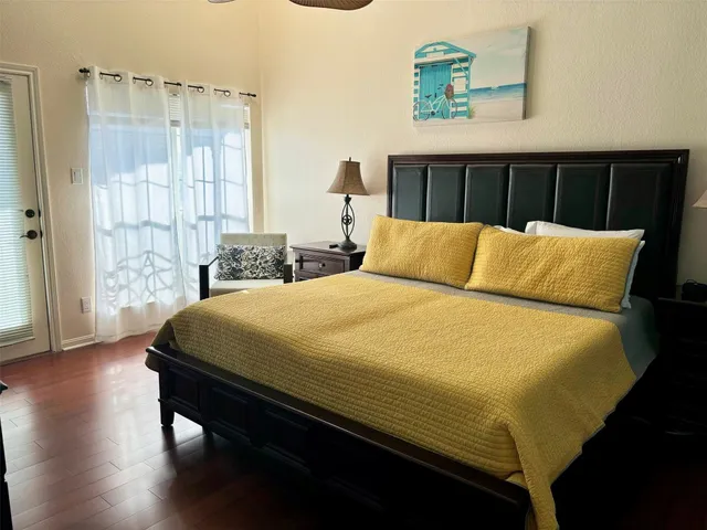 a bed sitting in a bedroom next to a window