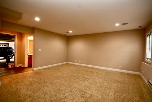 an empty room with closet and mirror