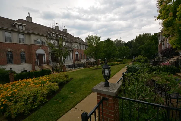 a view of a house with backyard and garden