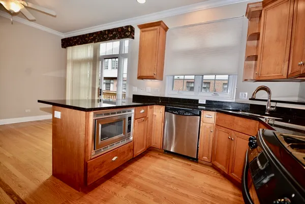 a kitchen with granite countertop a sink and cabinets