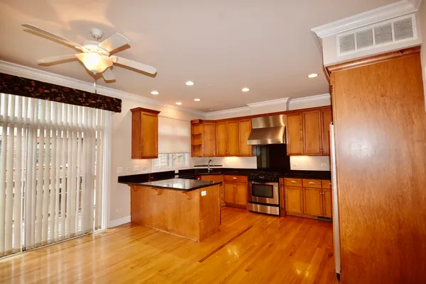 a kitchen with stainless steel appliances granite countertop a sink and a stove