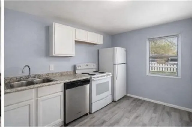 a kitchen with a sink stove and refrigerator