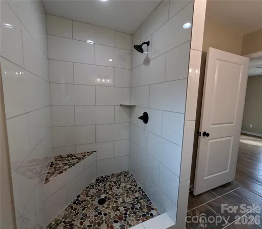 a bathroom with a glass door shower