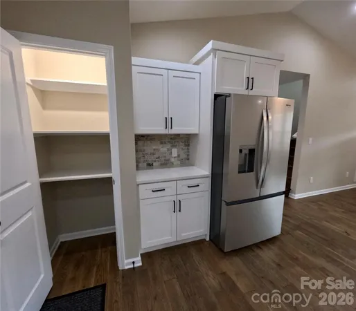 a kitchen with appliances and a refrigerator