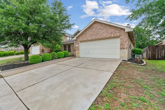 a view of a house with a yard and garage