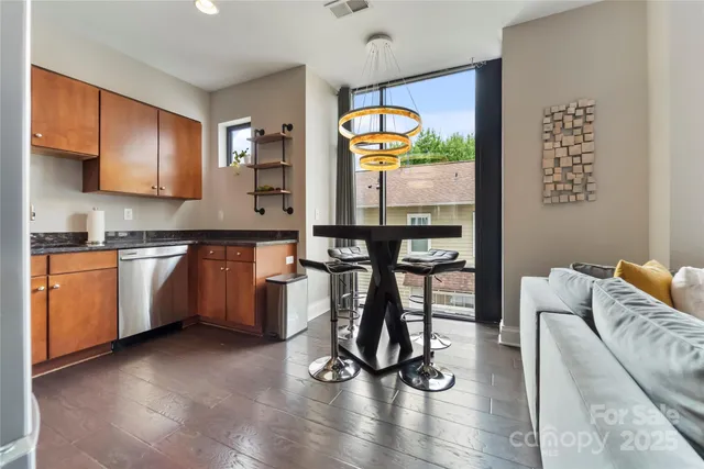 a kitchen with a table chairs refrigerator and a window