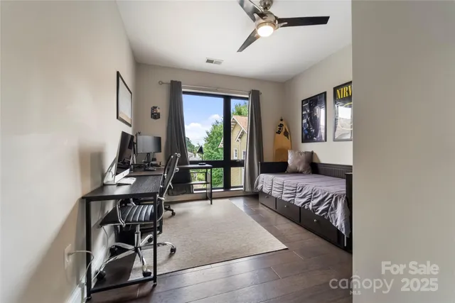 a bedroom with furniture and a large window