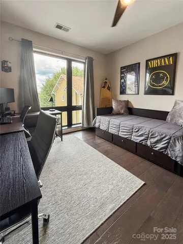 a living room with a bed furniture and a large window