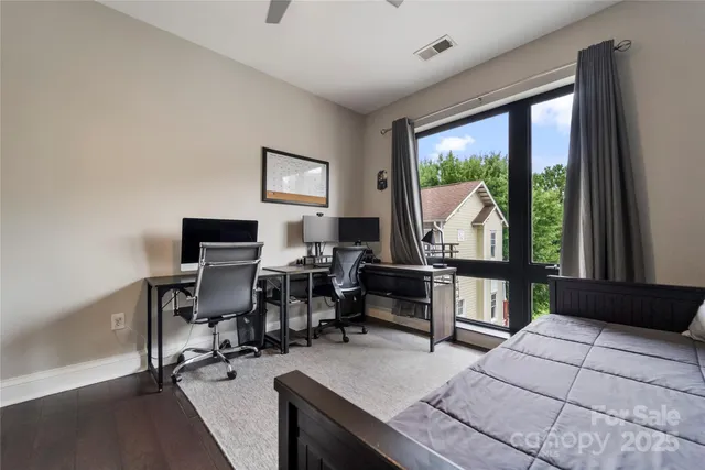 a living room with furniture a rug and a large window