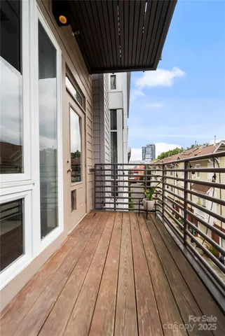 a view of outdoor space with wooden floor and city view