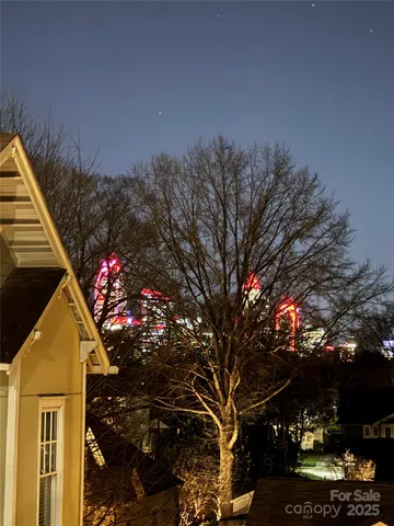 a front view of a house with a tree