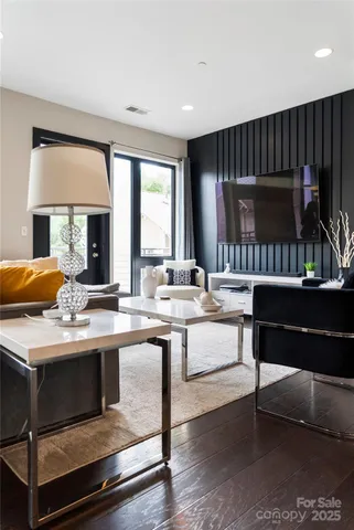 a living room with furniture a rug and a window