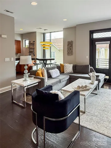 a living room with furniture a rug and a window