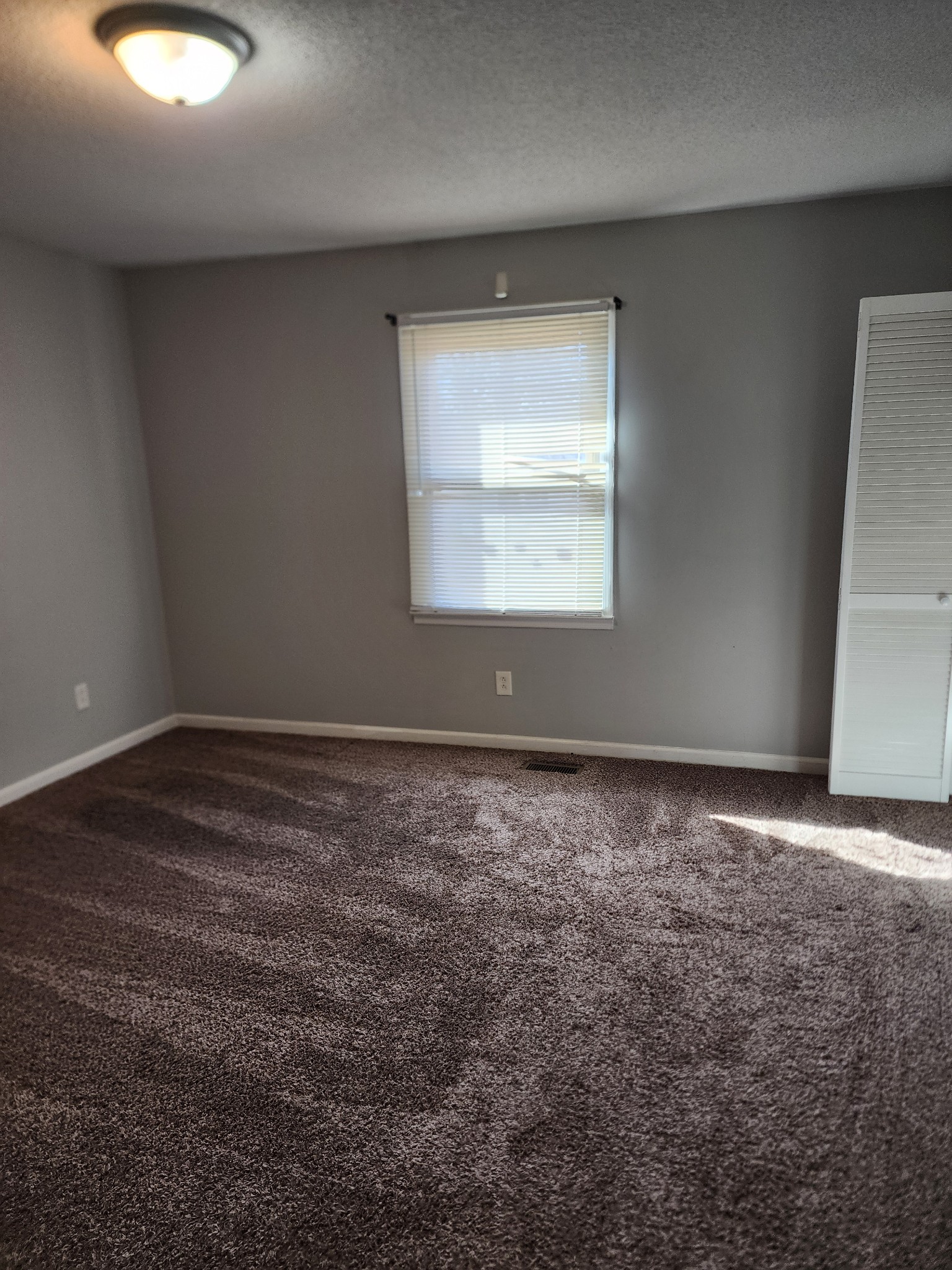 103 Helen Street Tullahoma, TN 37388 - Photo 3 of 10 an empty room with a empty space and a window
