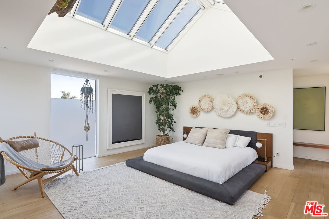 1220 Cabrillo Avenue Venice, CA 90291 - Photo 16 of 26 a bedroom with a bed and a chandelier