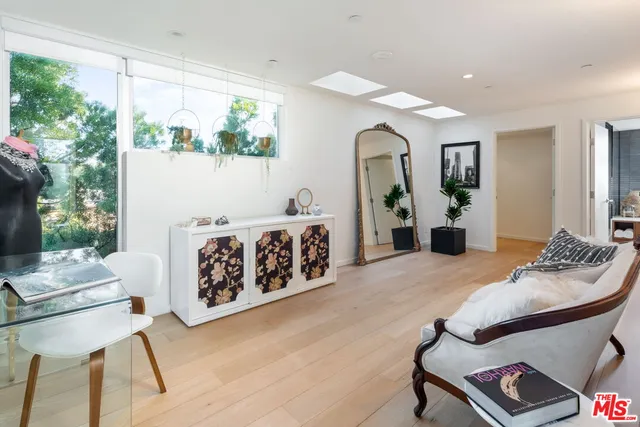 a bedroom with furniture and wooden floor