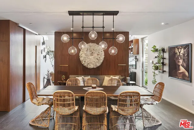 a dining room with furniture and wooden floor